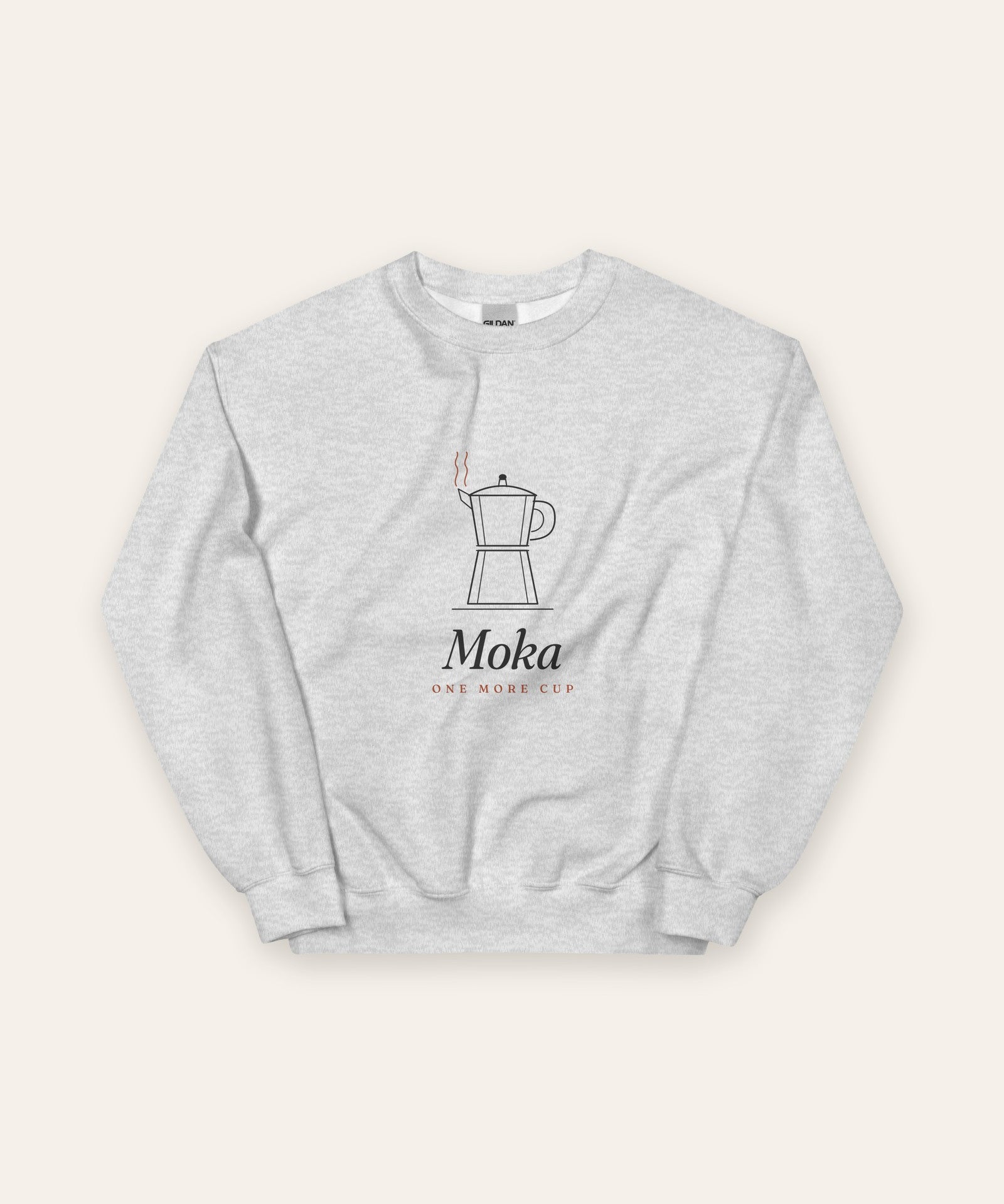 The Moka Crewneck in Ash, flat lay front, product shot on cream