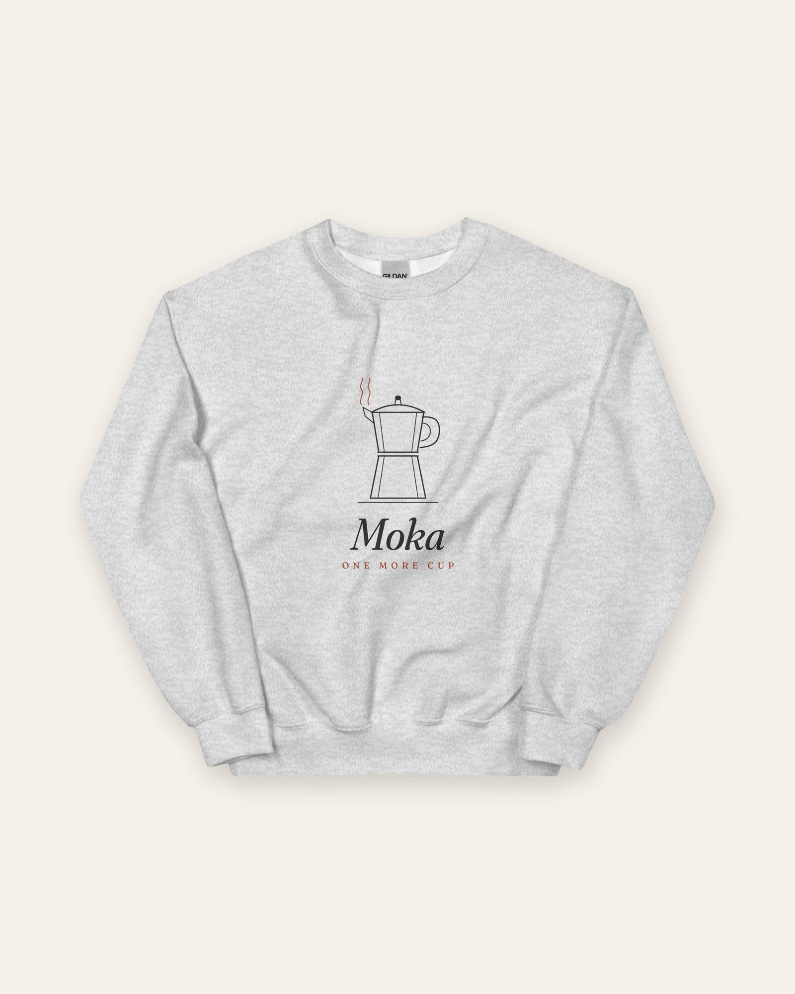 The Moka Crewneck in Ash, flat lay front, product shot on cream