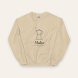 The Moka Crewneck in Sand, flat lay front, product shot on cream