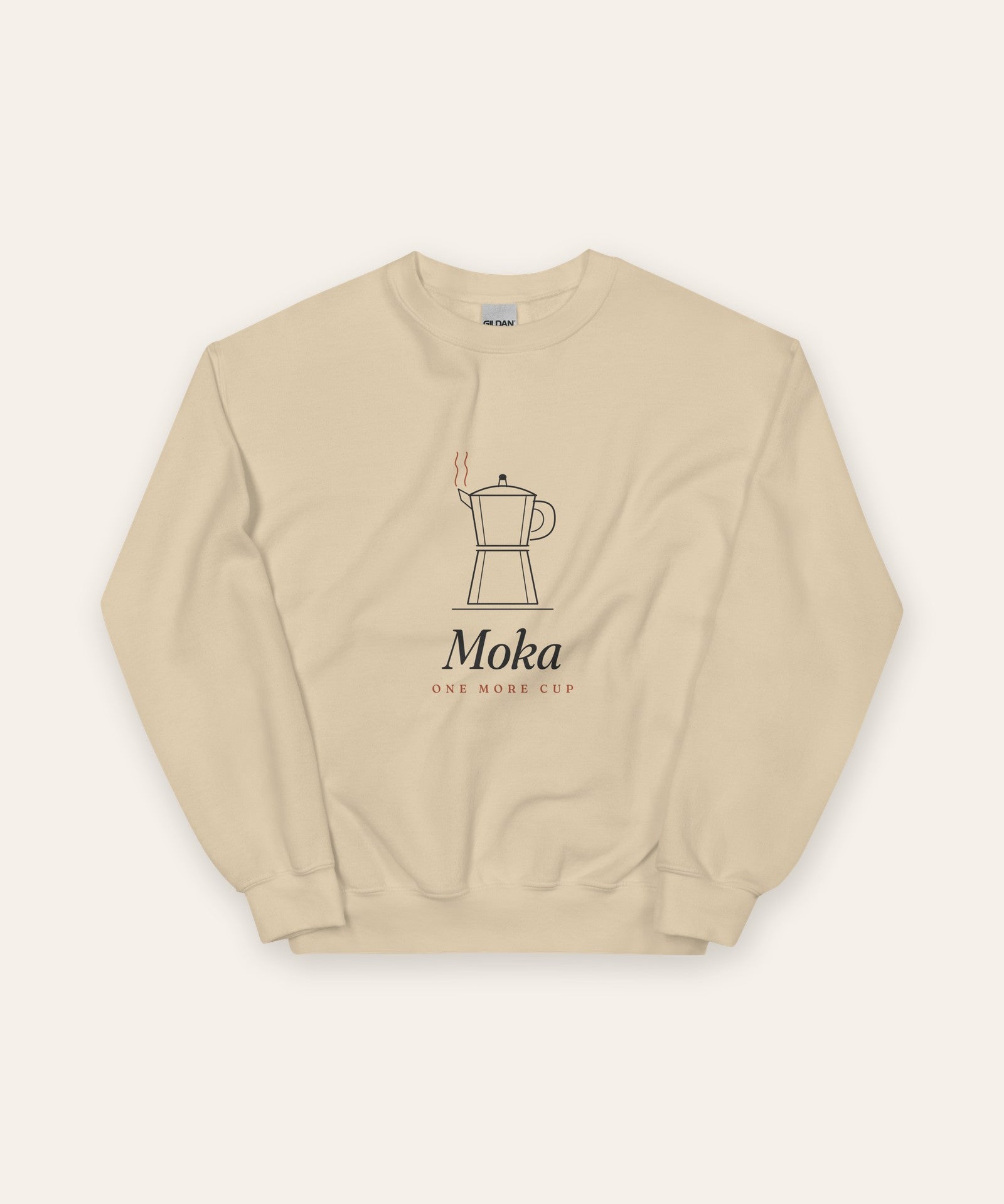 The Moka Crewneck in Sand, flat lay front, product shot on cream