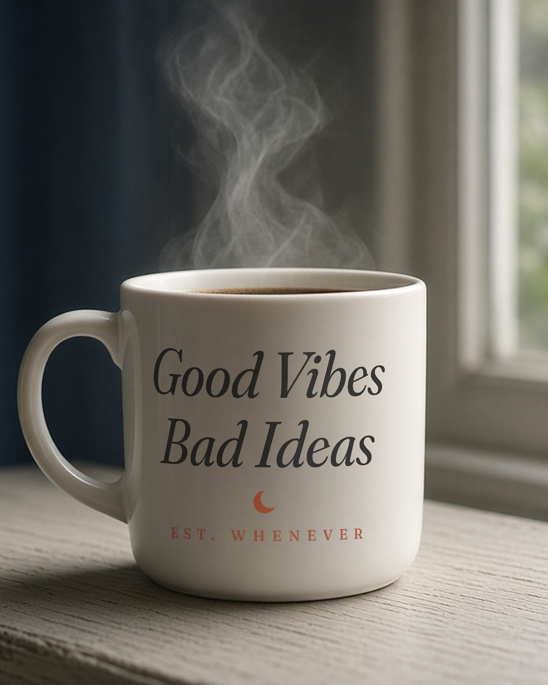 The House Mug in White 11 oz, steaming mug on a windowsill in morning light; handle right, so the crest side of the wrap faces camera (mug file puts the wordmark on the left half)
