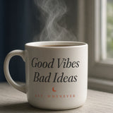 The House Mug in White 11 oz, steaming mug on a windowsill in morning light; handle right, so the crest side of the wrap faces camera (mug file puts the wordmark on the left half)