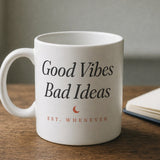 The House Mug in White 11 oz, mug (handle left, wordmark side to camera) beside an open notebook and a fountain pen
