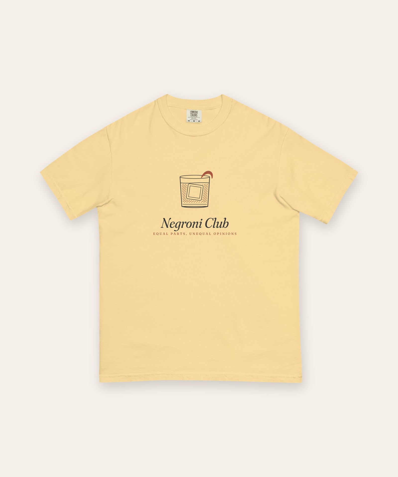 The Negroni Club Tee in Butter, flat lay front, product shot on cream