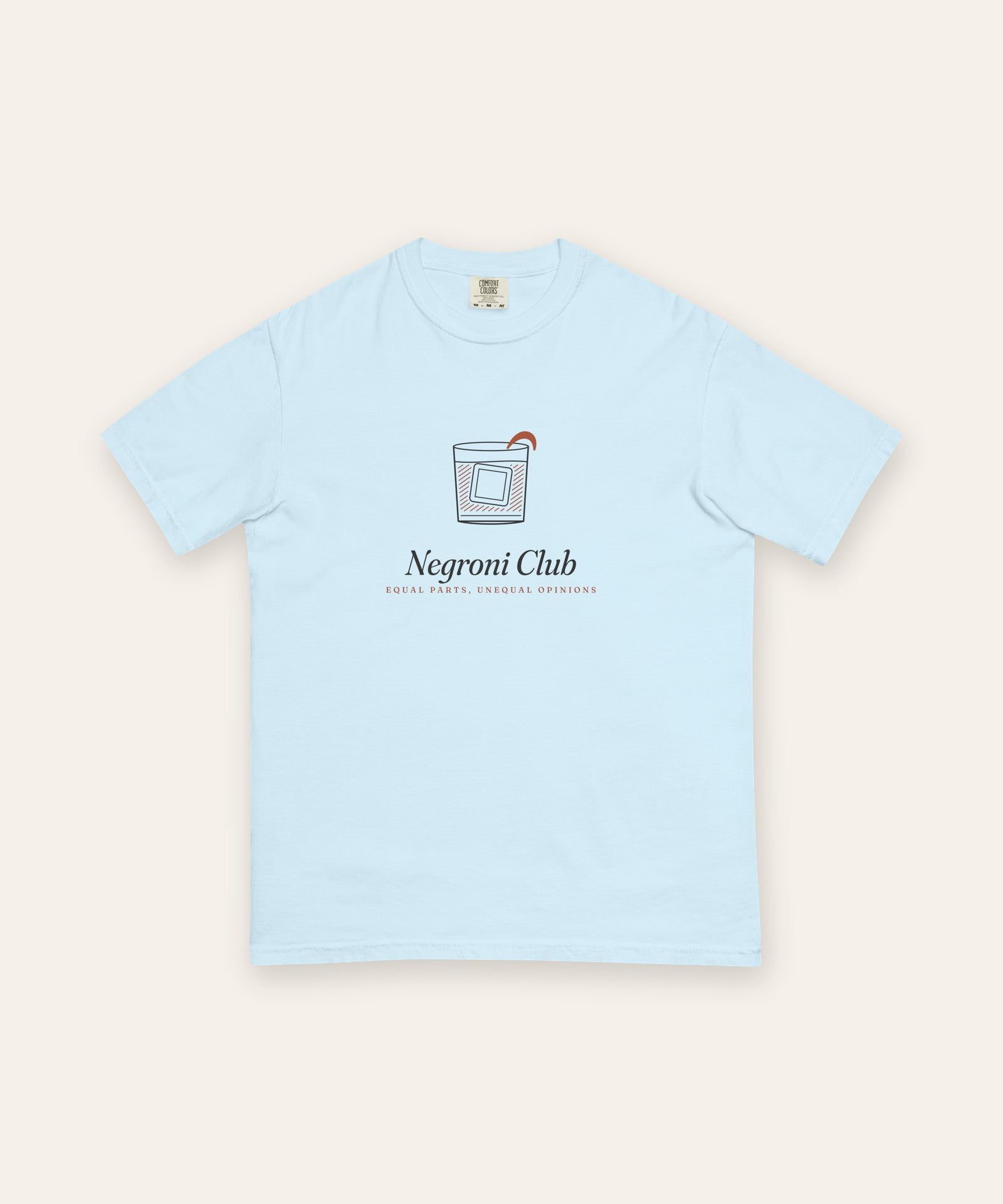 The Negroni Club Tee in Chambray, flat lay front, product shot on cream