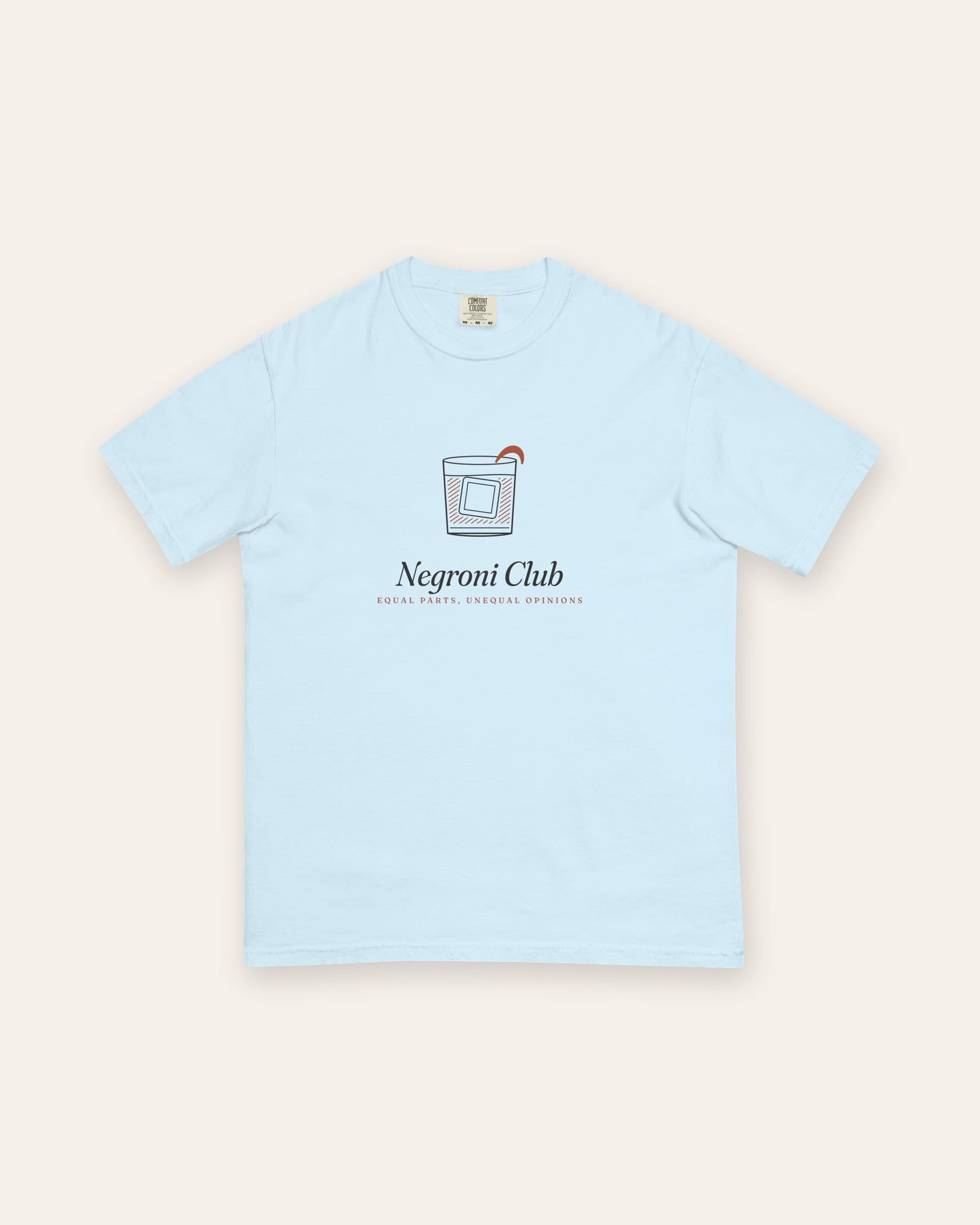 The Negroni Club Tee in Chambray, flat lay front, product shot on cream