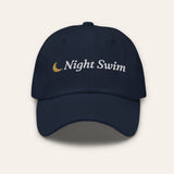 The Night Swim Dad Hat in Navy, flat lay front, product shot on cream