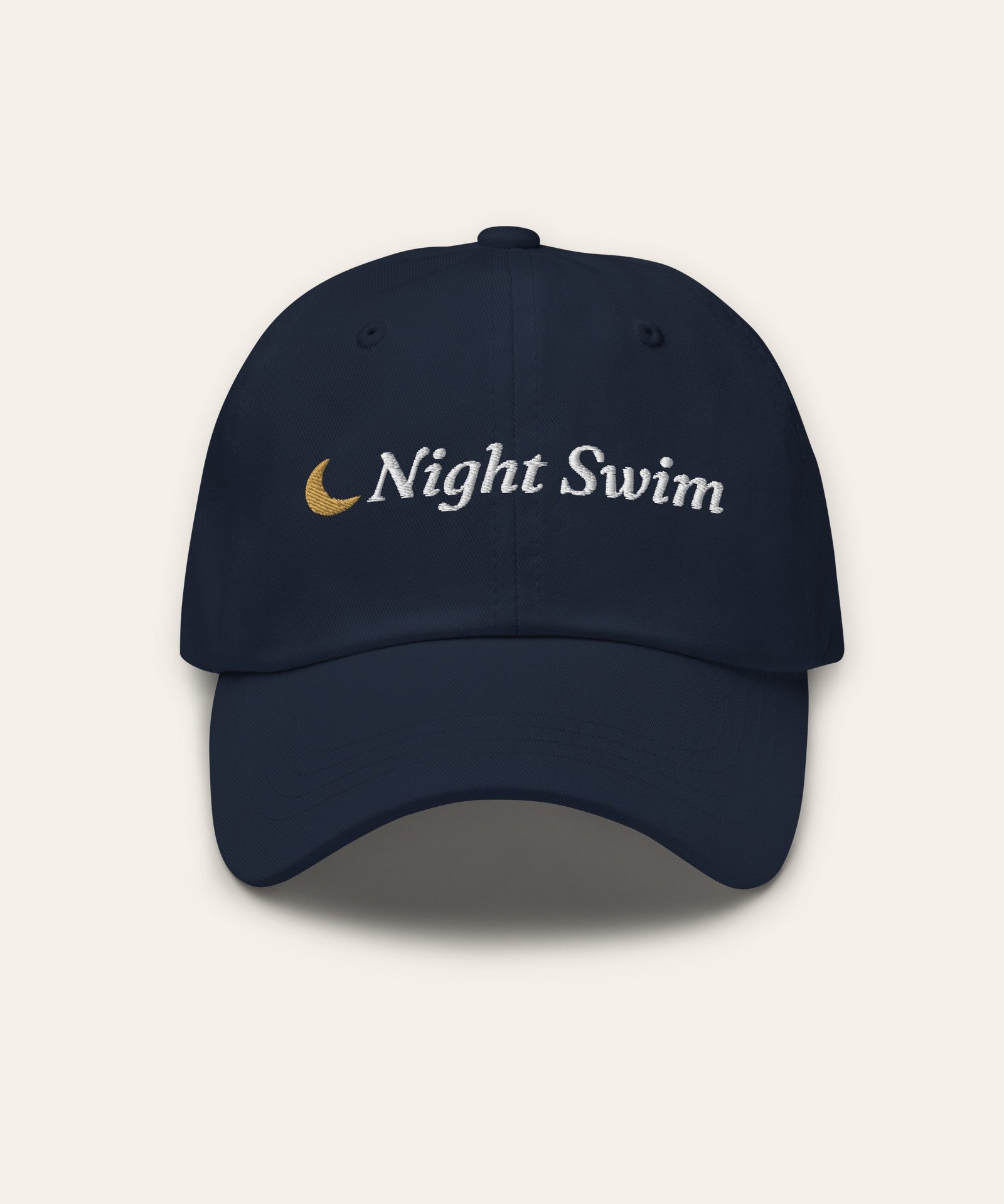 The Night Swim Dad Hat in Navy, flat lay front, product shot on cream