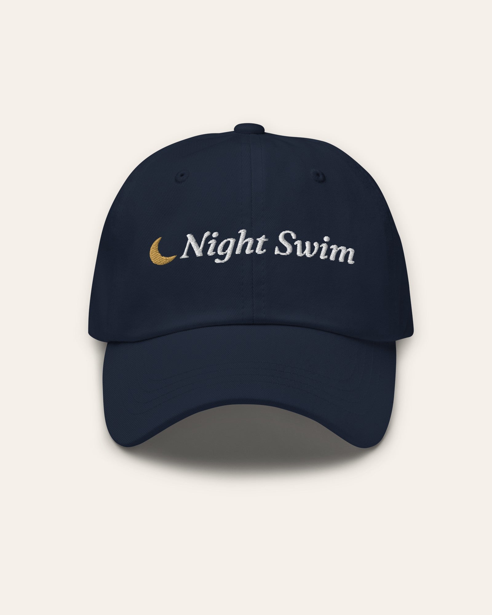 The Night Swim Dad Hat in Navy, flat lay front, product shot on cream