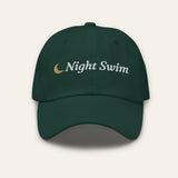 The Night Swim Dad Hat in Spruce, flat lay front, product shot on cream