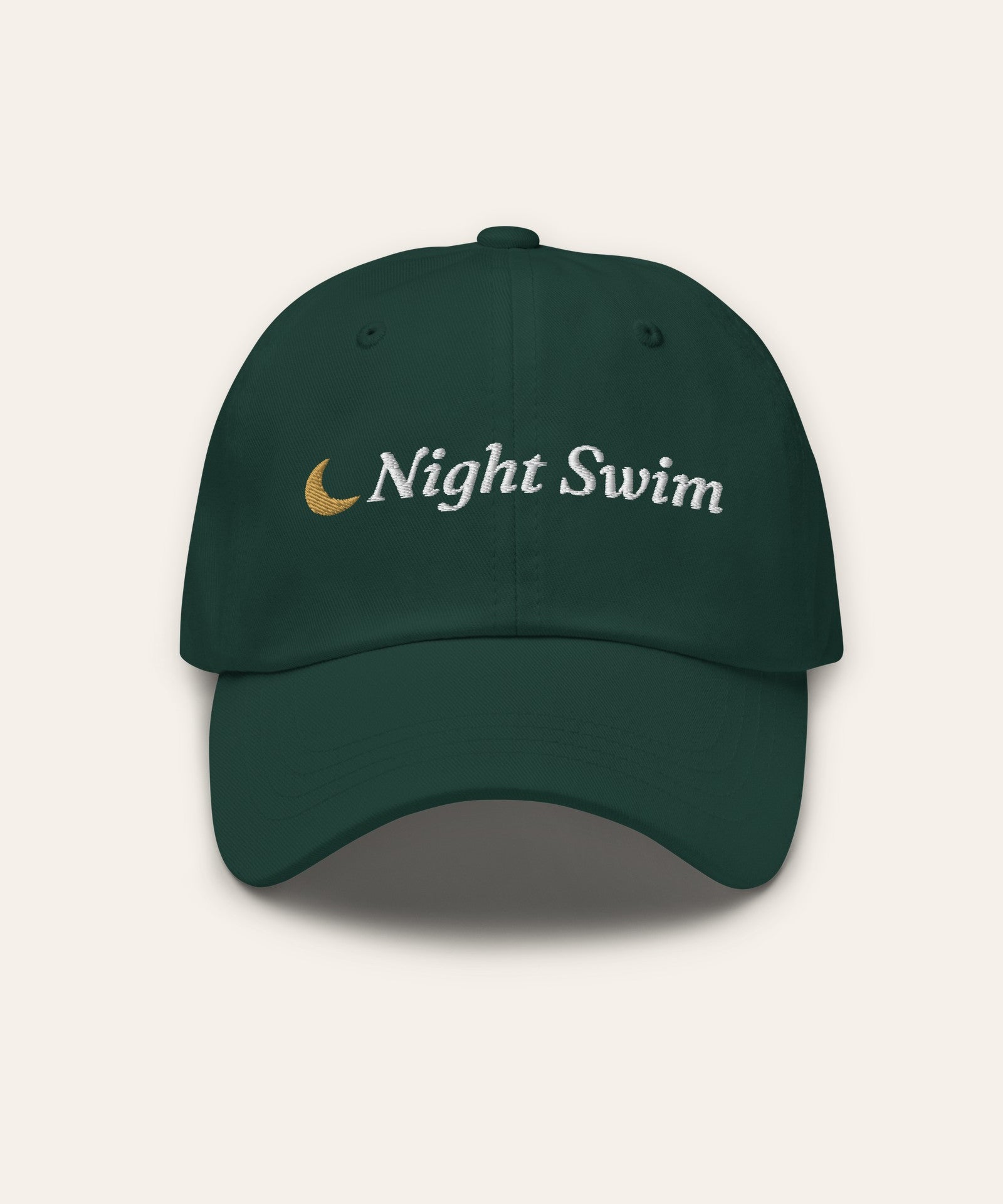 The Night Swim Dad Hat in Spruce, flat lay front, product shot on cream