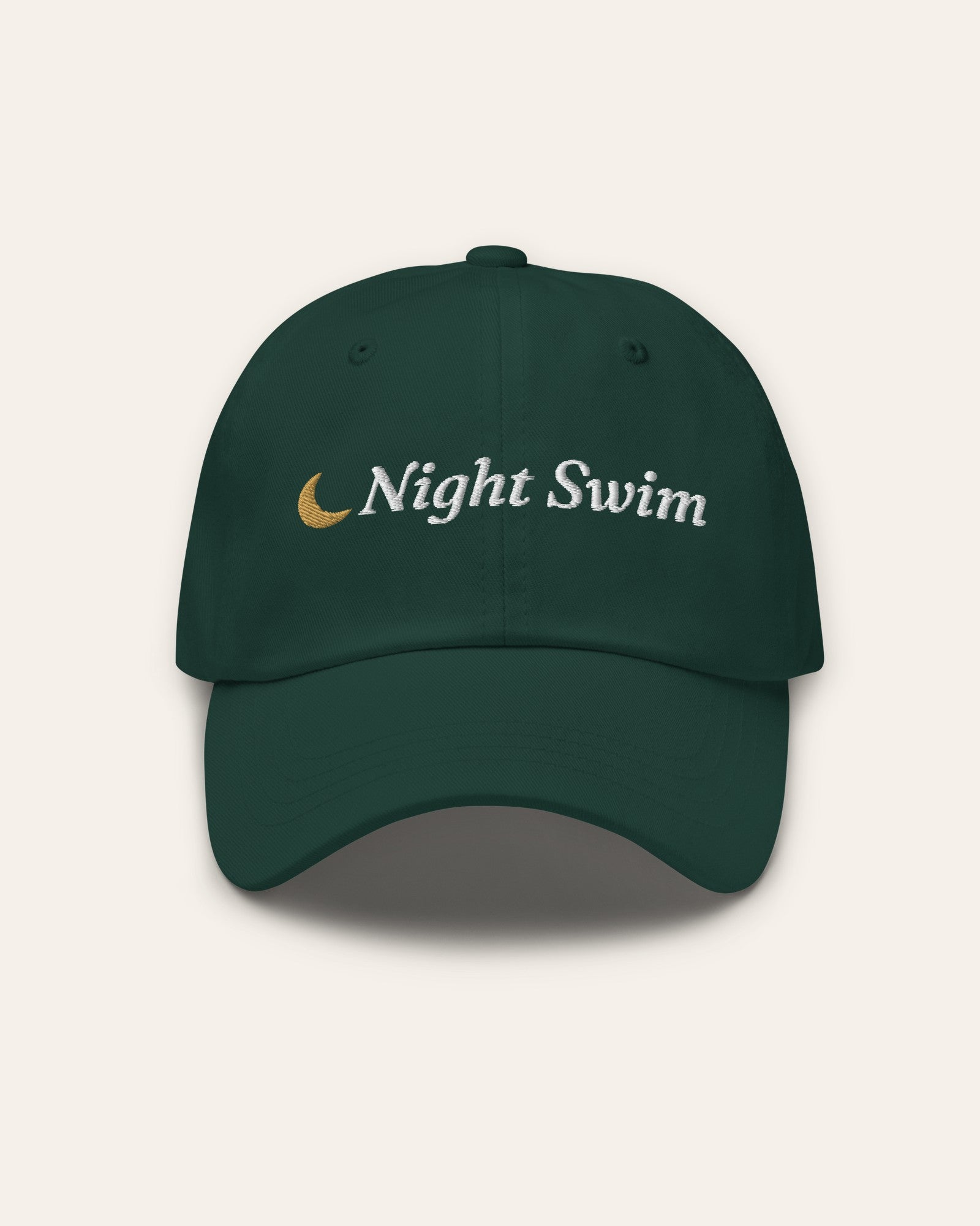 The Night Swim Dad Hat in Spruce, flat lay front, product shot on cream