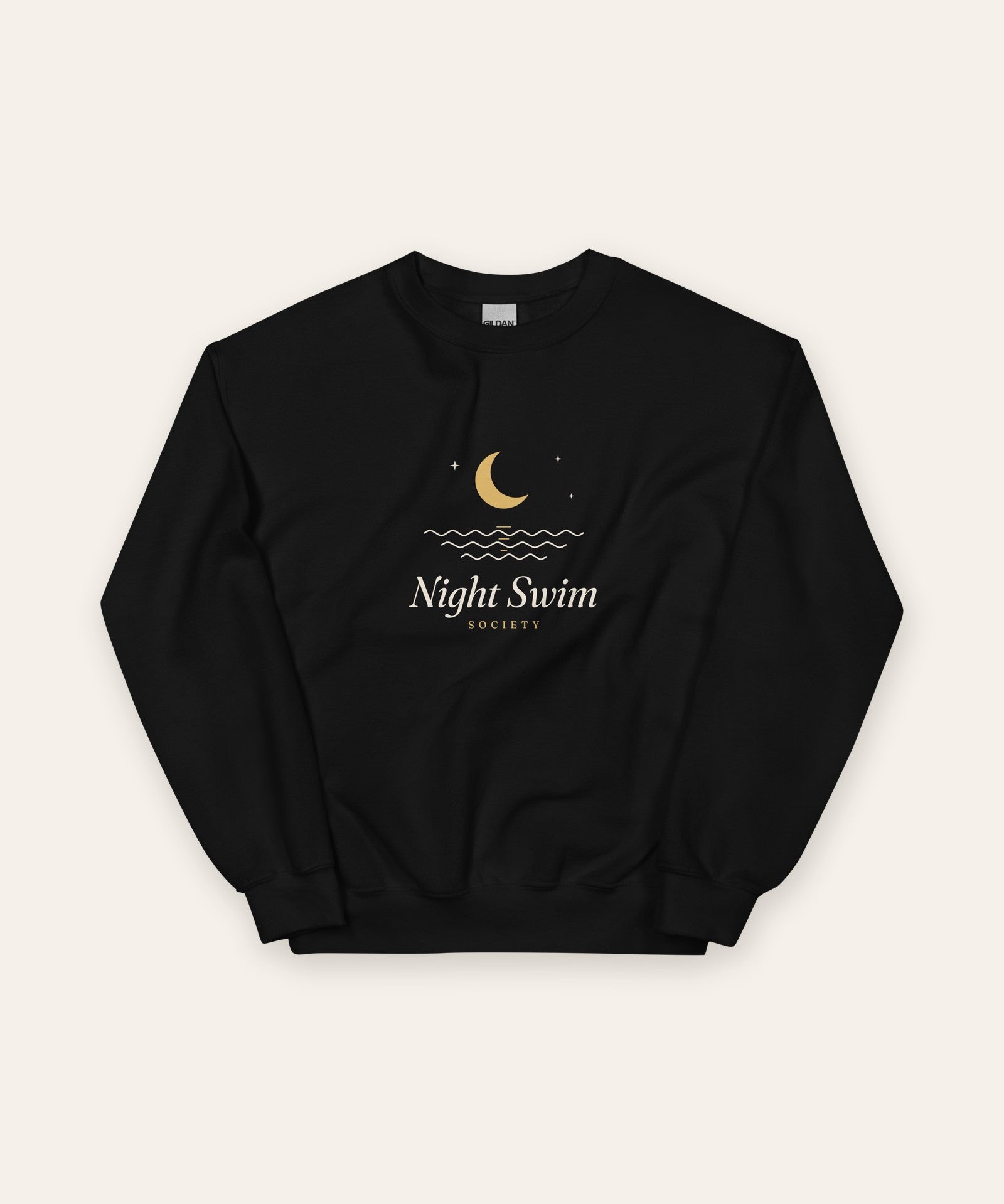 The Night Swim Society Crewneck in Black, flat lay front, product shot on cream