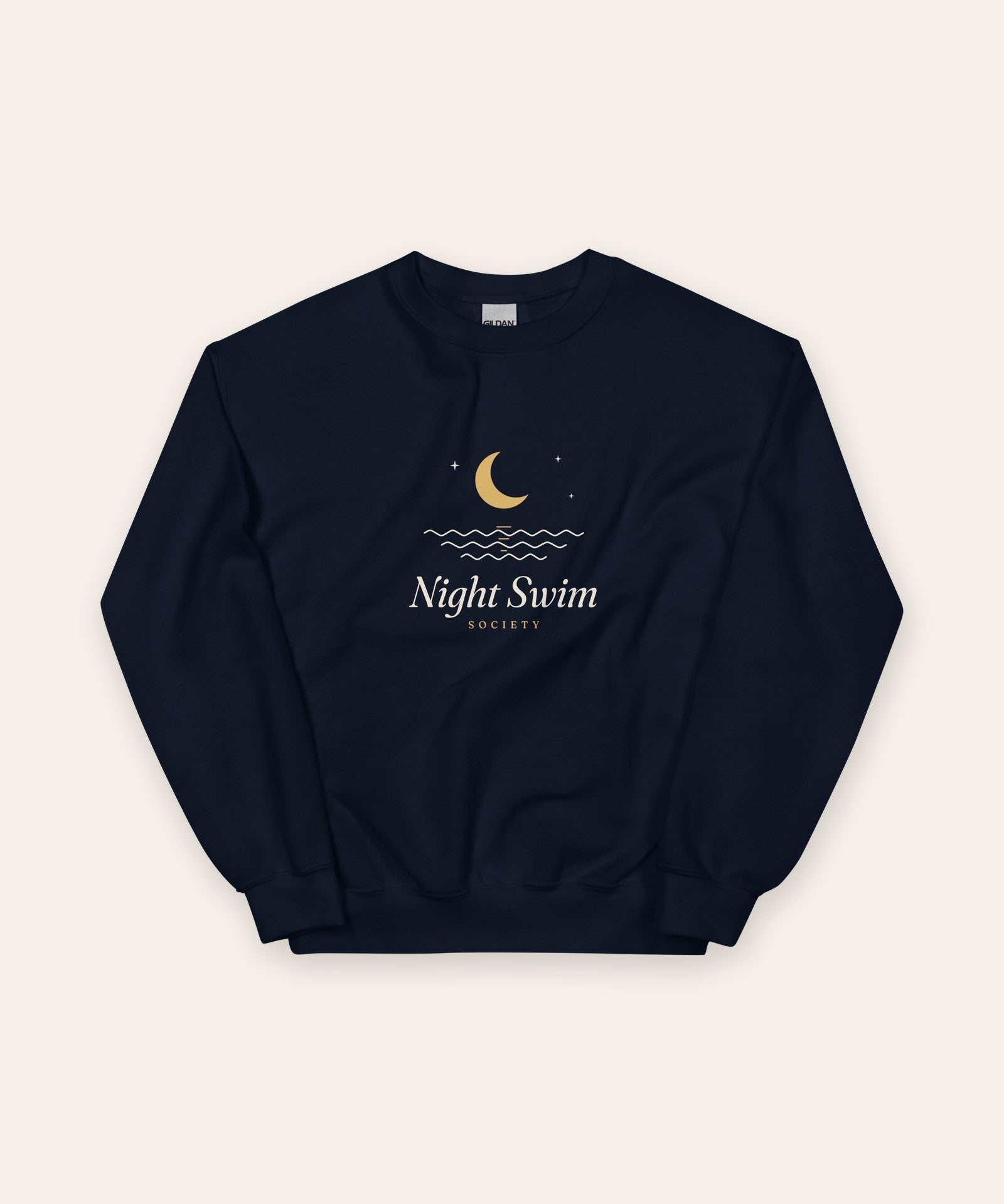 The Night Swim Society Crewneck in Navy, flat lay front, product shot on cream