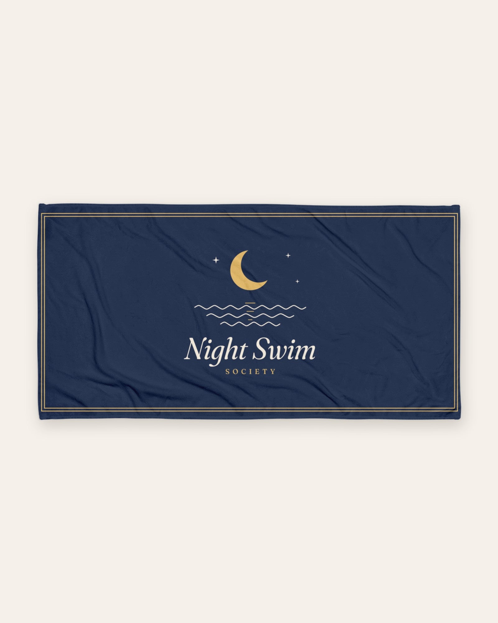 The Night Swim Beach Towel, product shot on cream