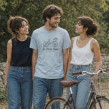 Le Petit Tour Tee in Chambray, man in the centre between two women on a country lane by a stone wall, vintage bike in front