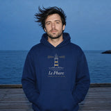 Le Phare Hoodie in Navy Blazer, a man (30s), hood down, hands in the pocket, hair blowing sideways on a pier at blue hour