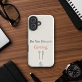 The Do Not Disturb Carving Phone Case on a wooden desk