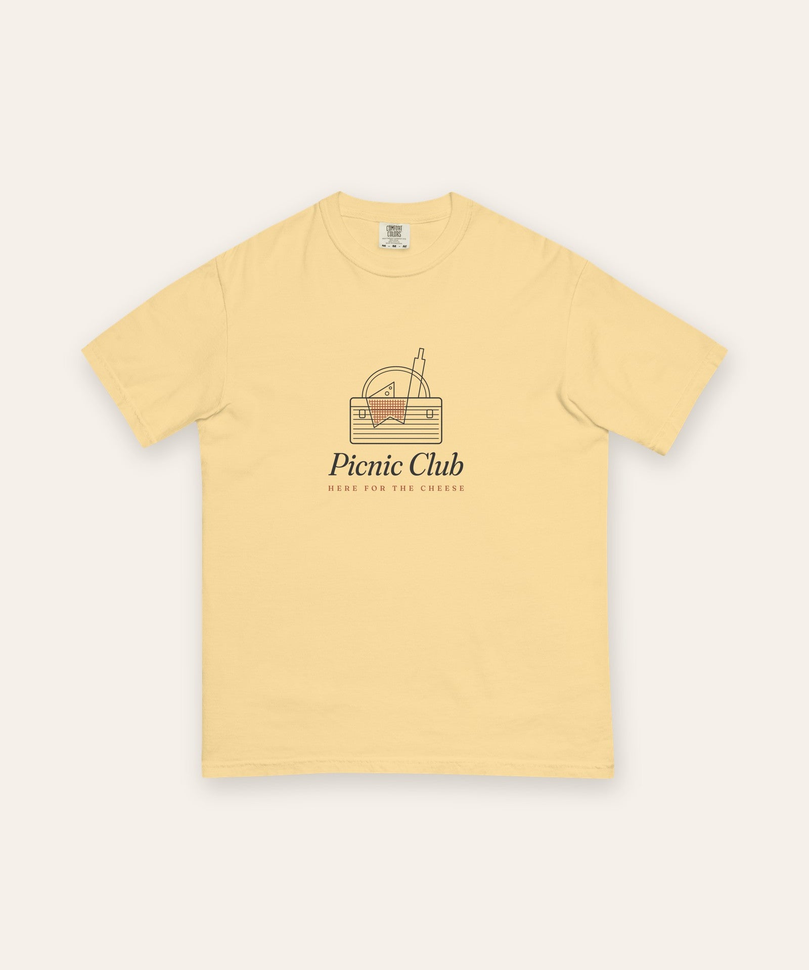 The Picnic Club Tee in Butter, flat lay front, product shot on cream