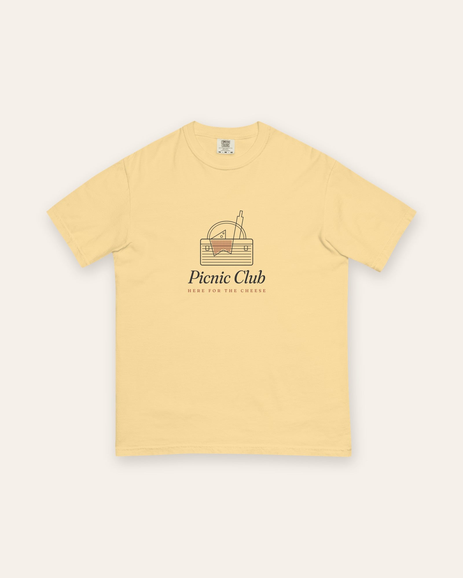 The Picnic Club Tee in Butter, flat lay front, product shot on cream