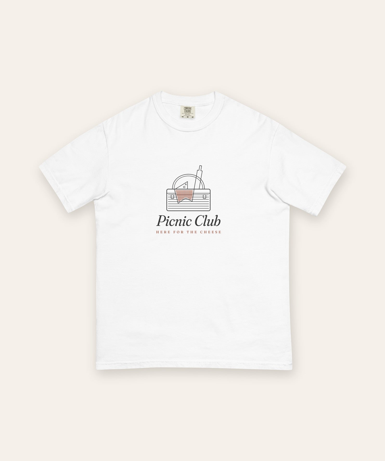 The Picnic Club Tee in White, flat lay front, product shot on cream