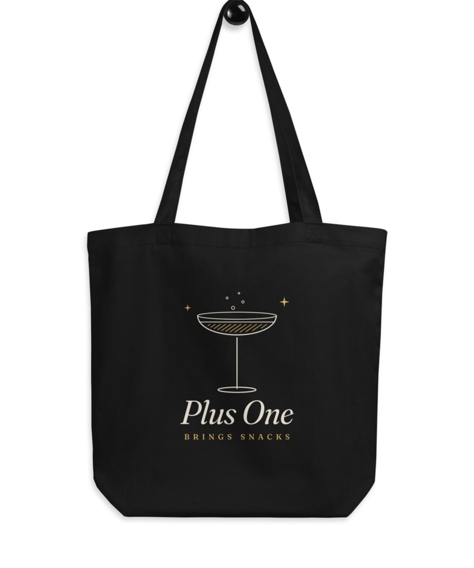The Plus One Tote in Black, flat lay front, product shot on cream