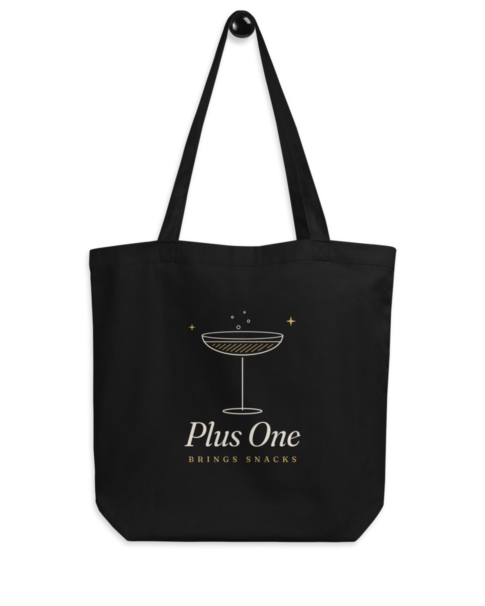 The Plus One Tote in Black, flat lay front, product shot on cream