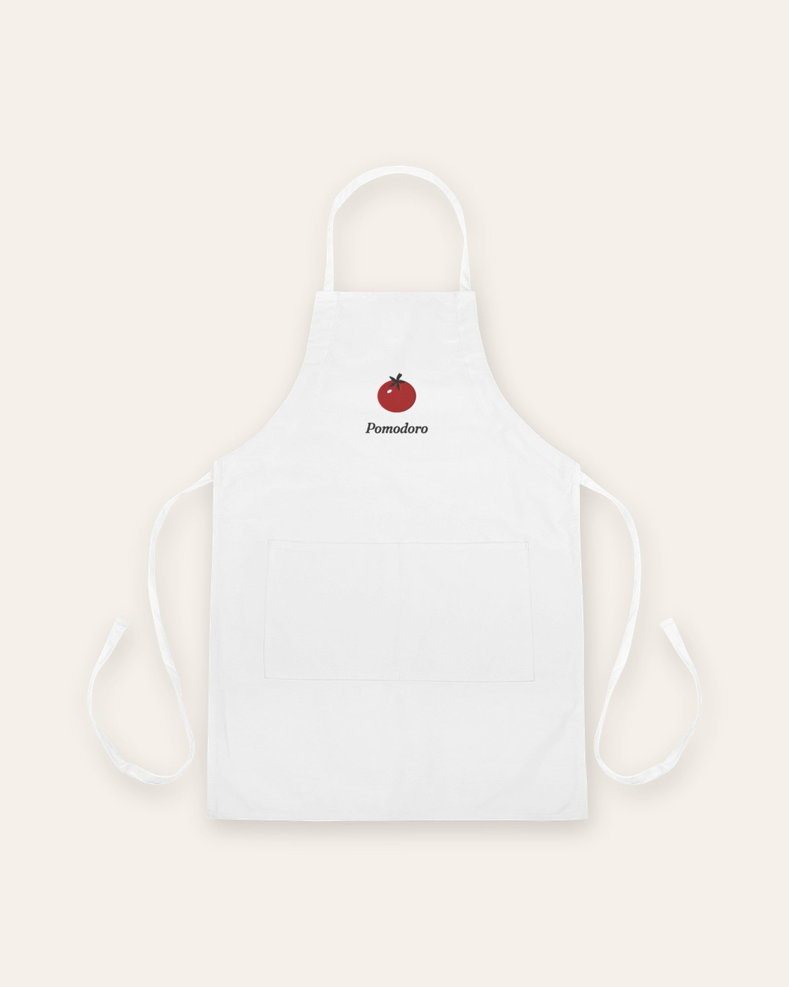 The Pomodoro Apron in White, flat lay front, product shot on cream