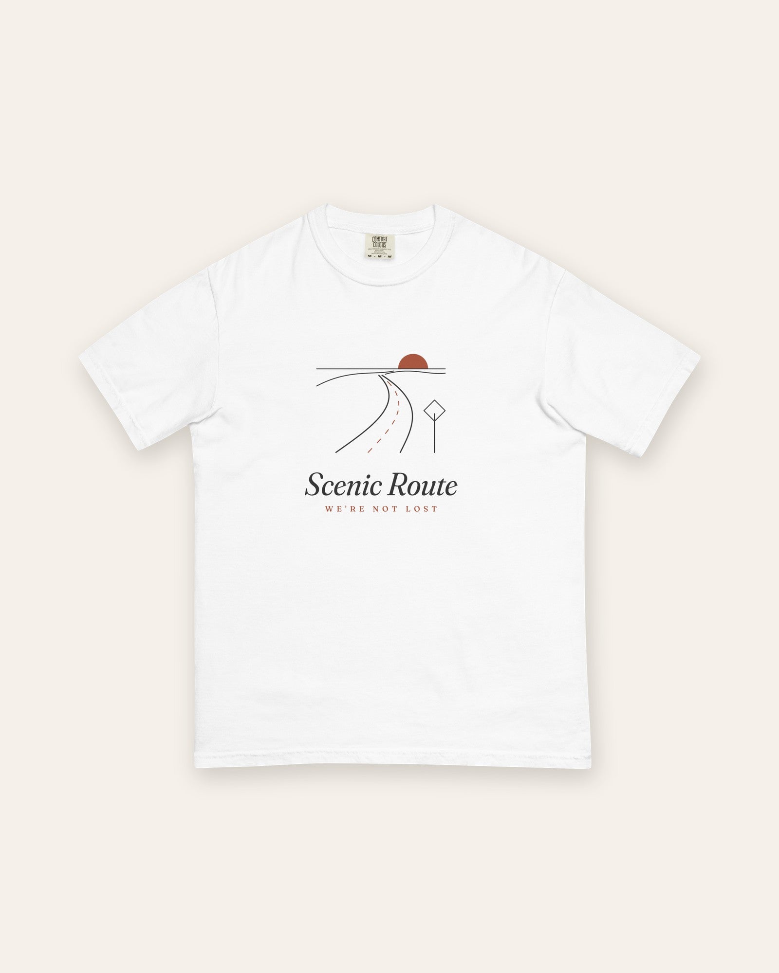 The Scenic Route Tee in White, flat lay front, product shot on cream