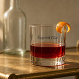 The Negroni Club Rocks Glass in Clear 10.5 oz, Negroni with an orange twist on a brass bar cart