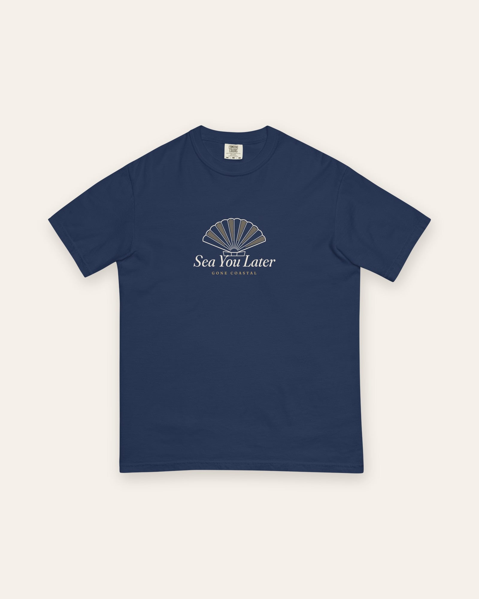 The Sea You Later Tee in True Navy, flat lay front, product shot on cream