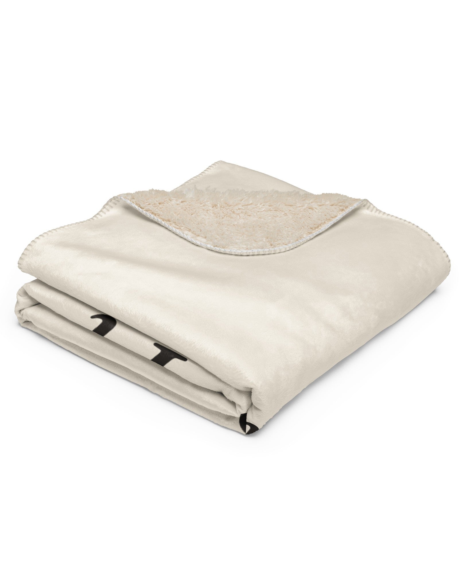 The Snowed In Sherpa Blanket in Tan, neatly folded