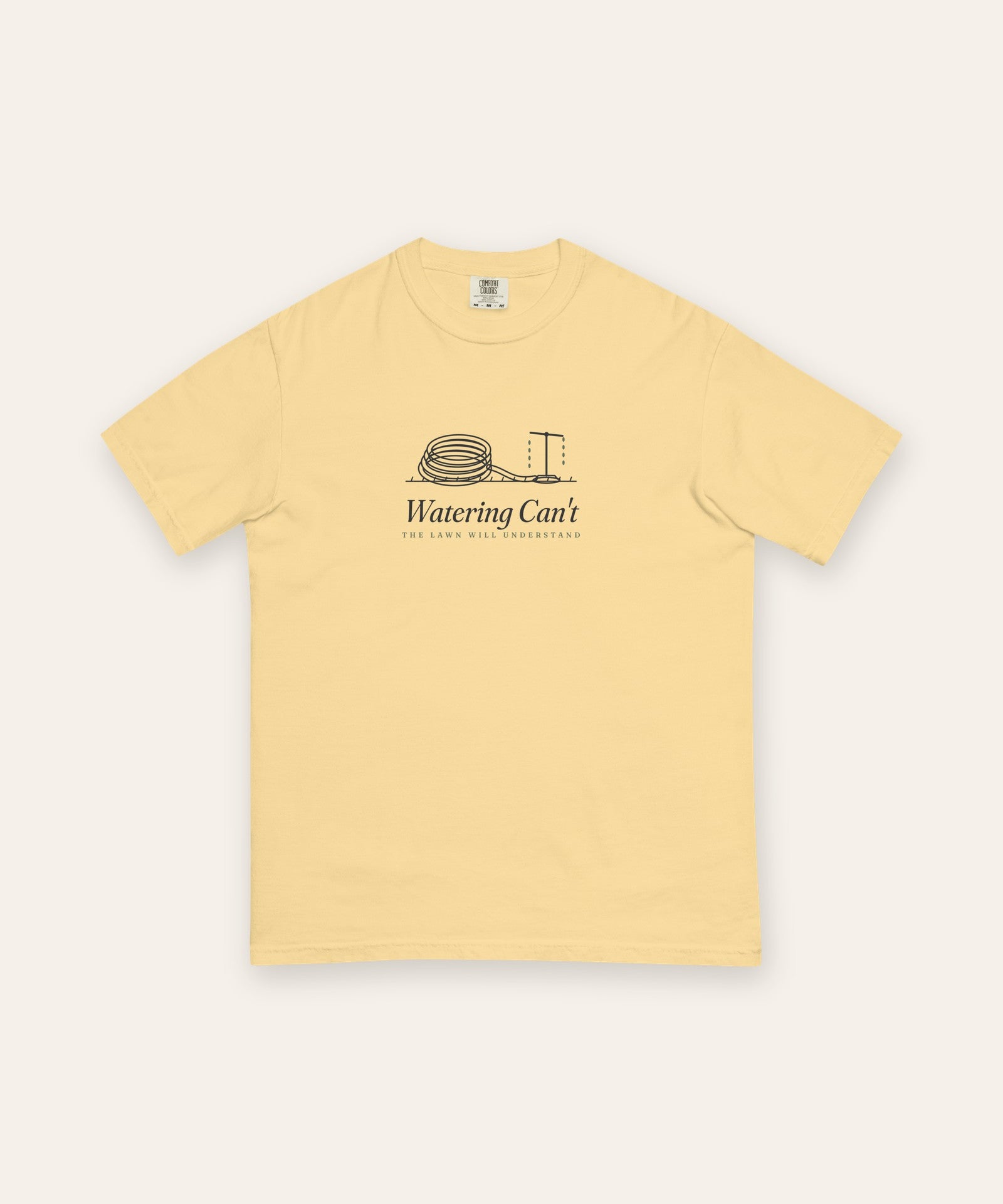 The Watering Can't Tee in Butter, flat lay front, product shot on cream