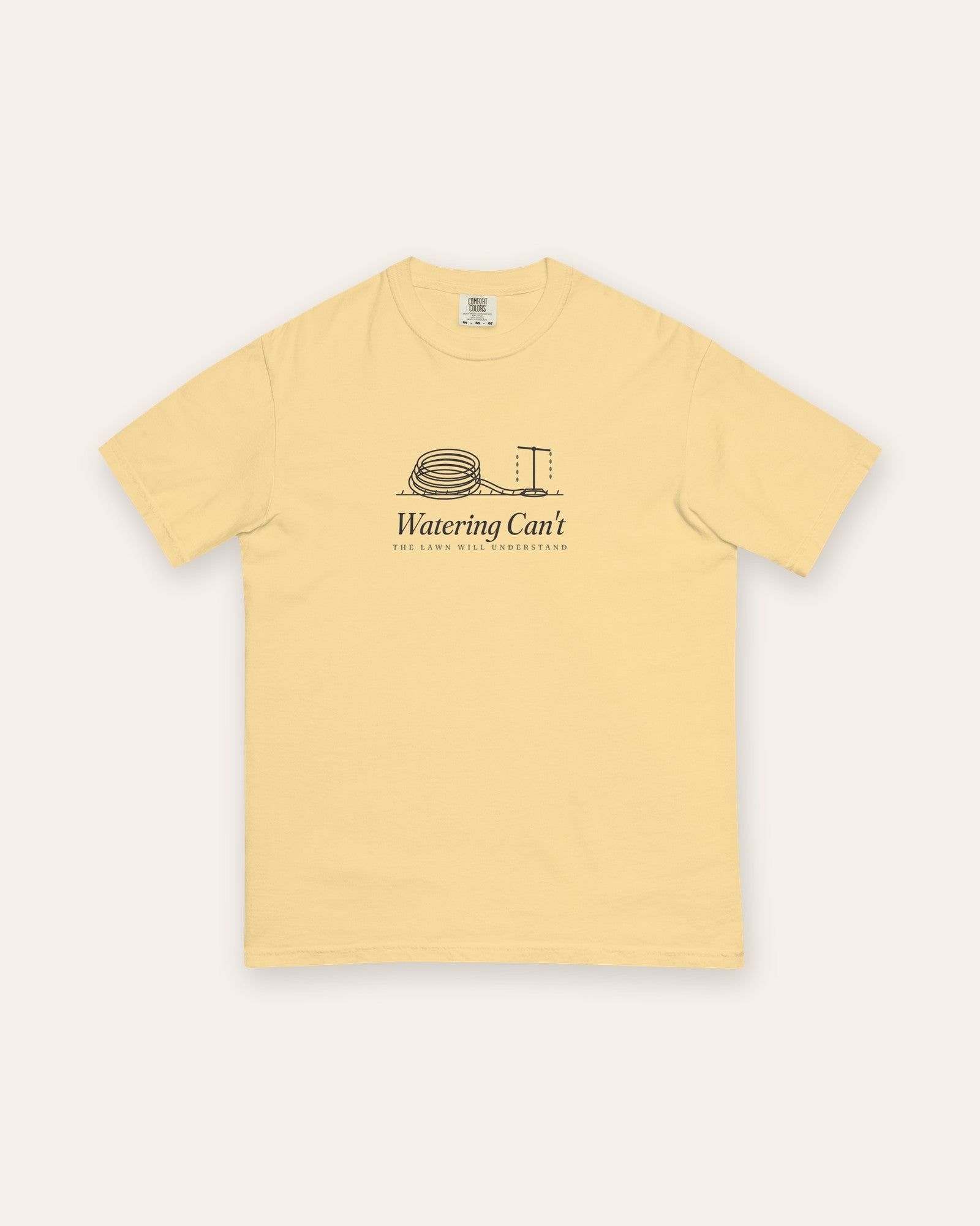 The Watering Can't Tee in Butter, flat lay front, product shot on cream