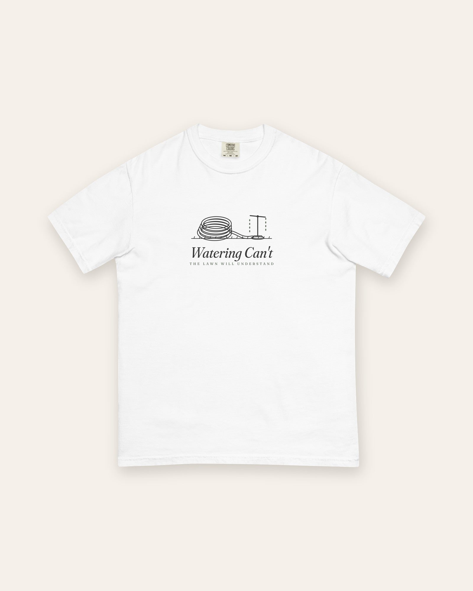 The Watering Can't Tee in White, flat lay front, product shot on cream