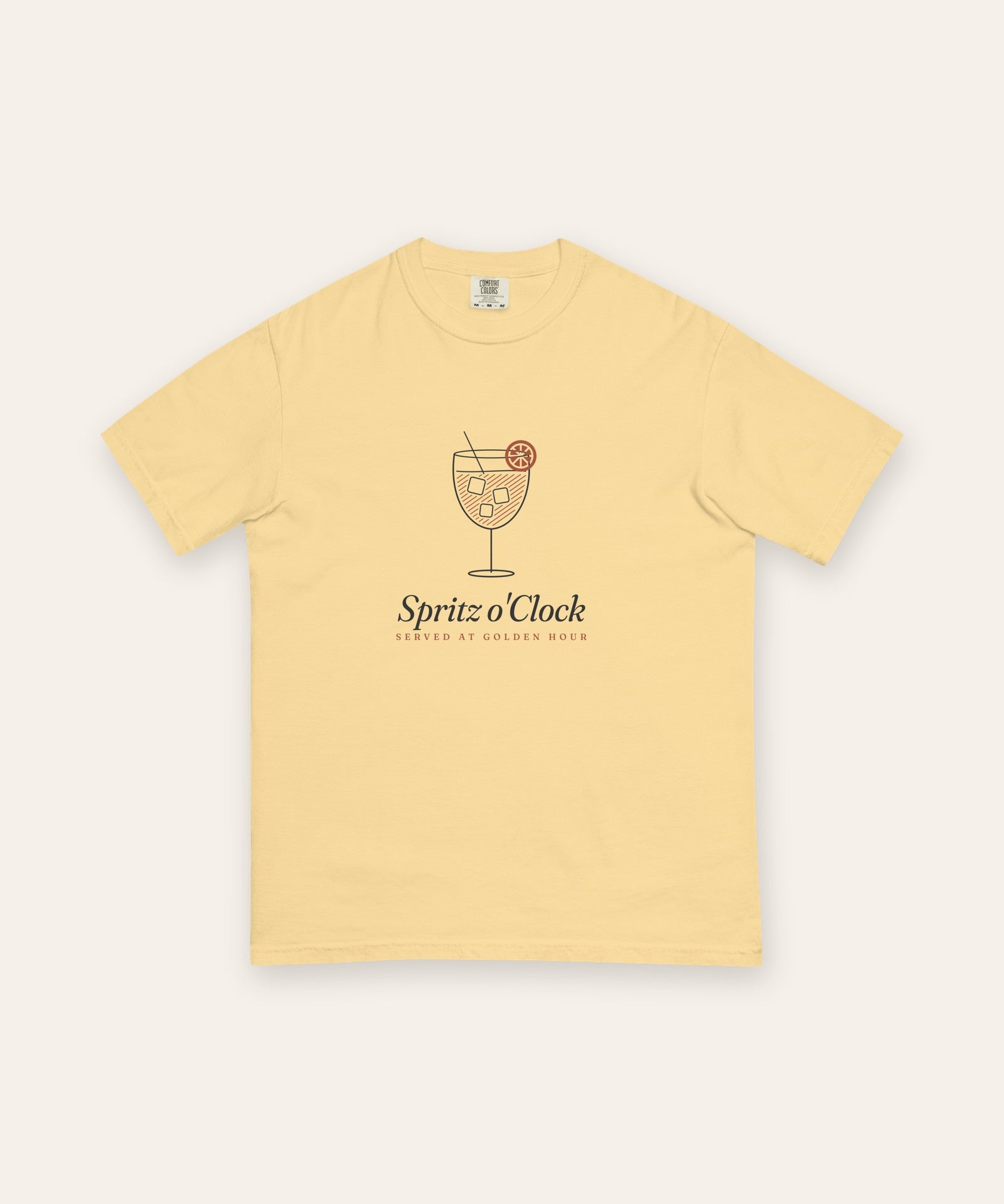 The Spritz o'Clock Tee in Butter, flat lay front, product shot on cream