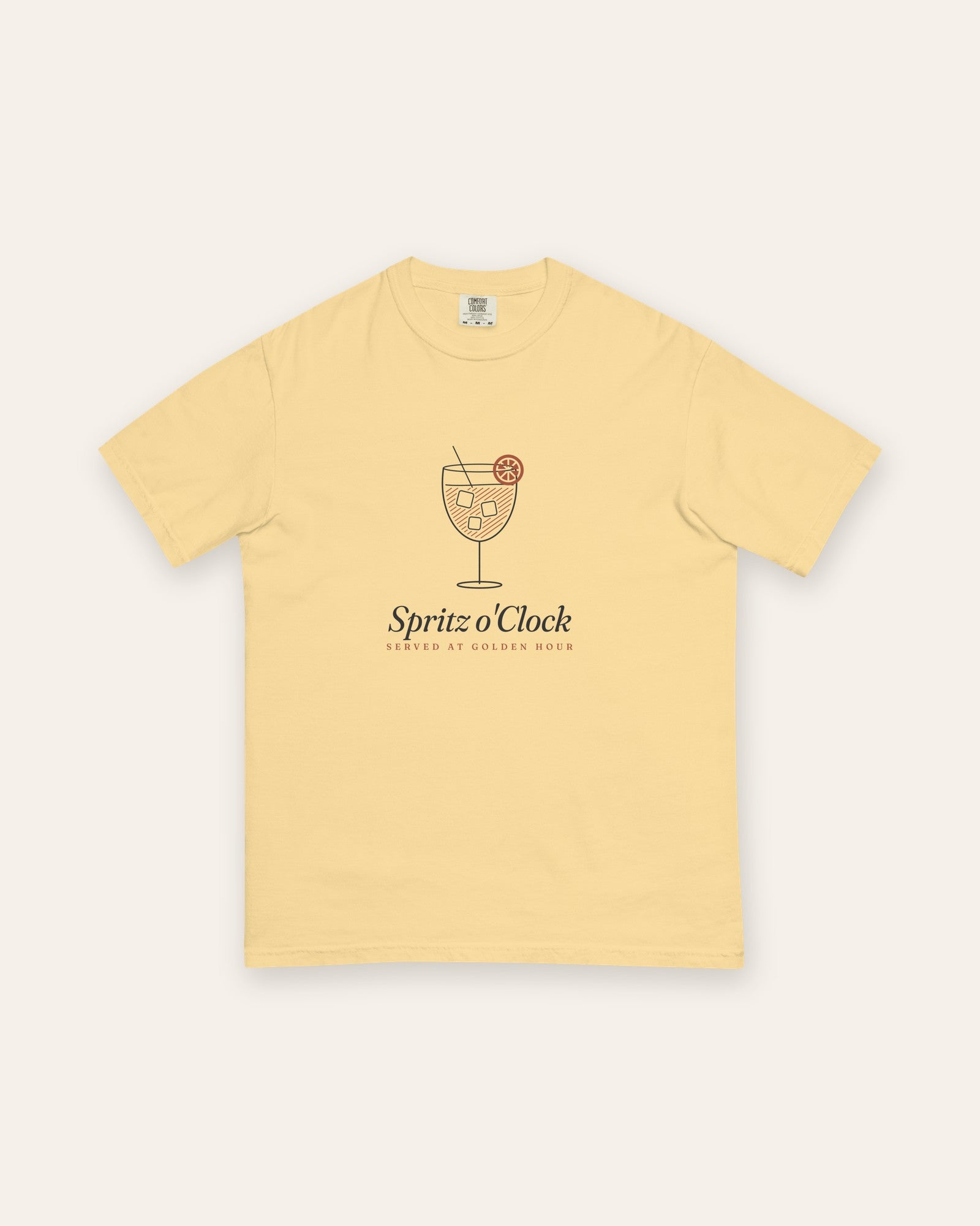 The Spritz o'Clock Tee in Butter, flat lay front, product shot on cream