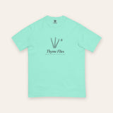The Thyme Flies Tee in Chalky Mint, flat lay front, product shot on cream