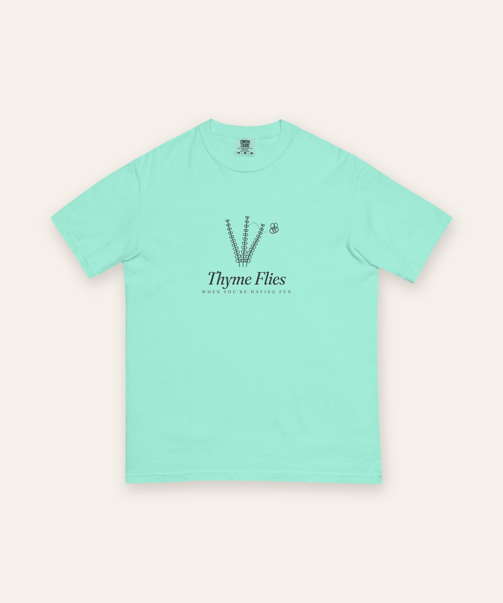 The Thyme Flies Tee in Chalky Mint, flat lay front, product shot on cream
