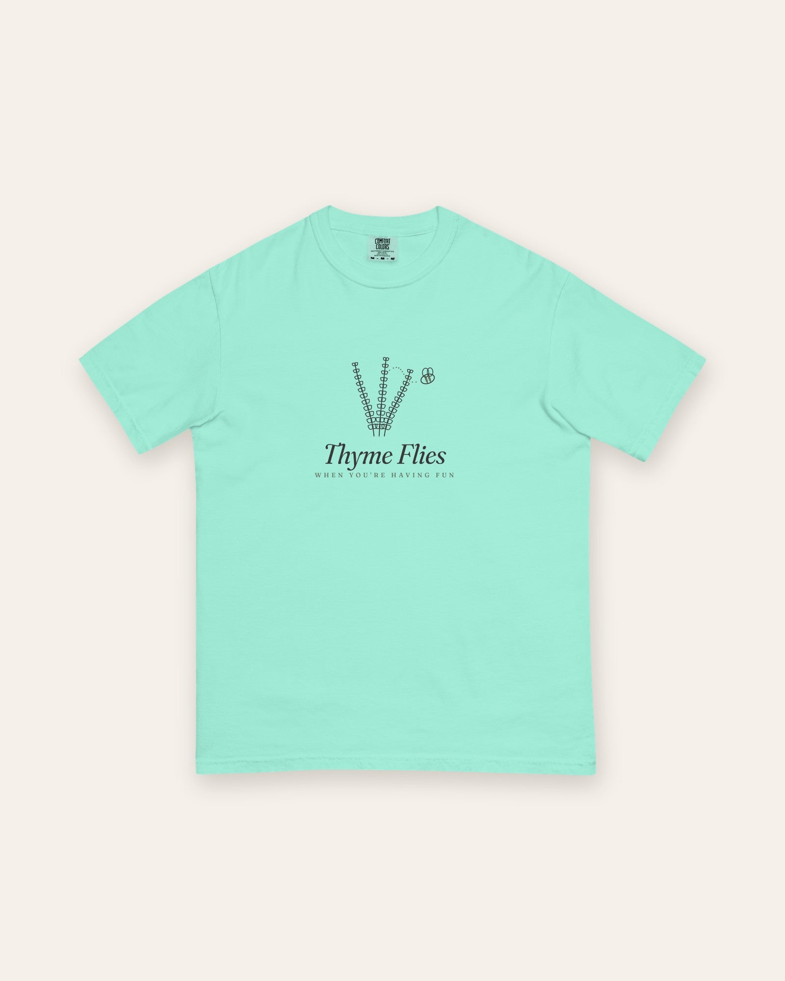 The Thyme Flies Tee in Chalky Mint, flat lay front, product shot on cream
