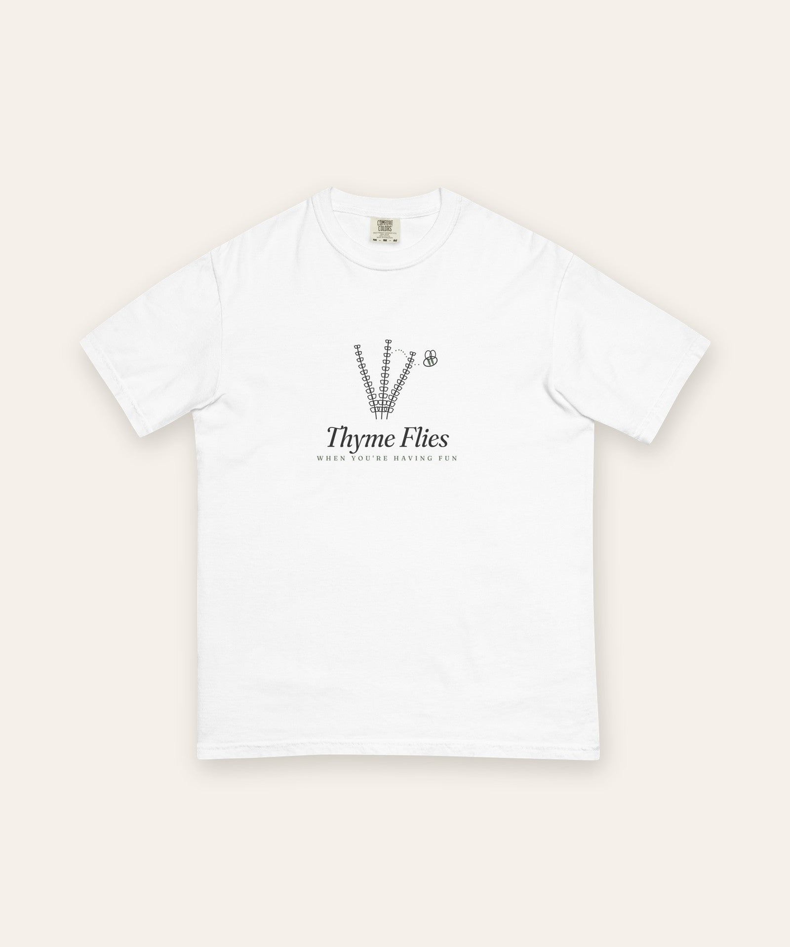 The Thyme Flies Tee in White, flat lay front, product shot on cream