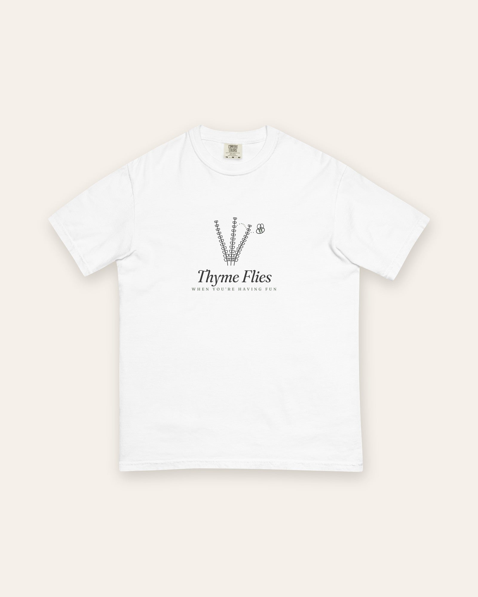 The Thyme Flies Tee in White, flat lay front, product shot on cream