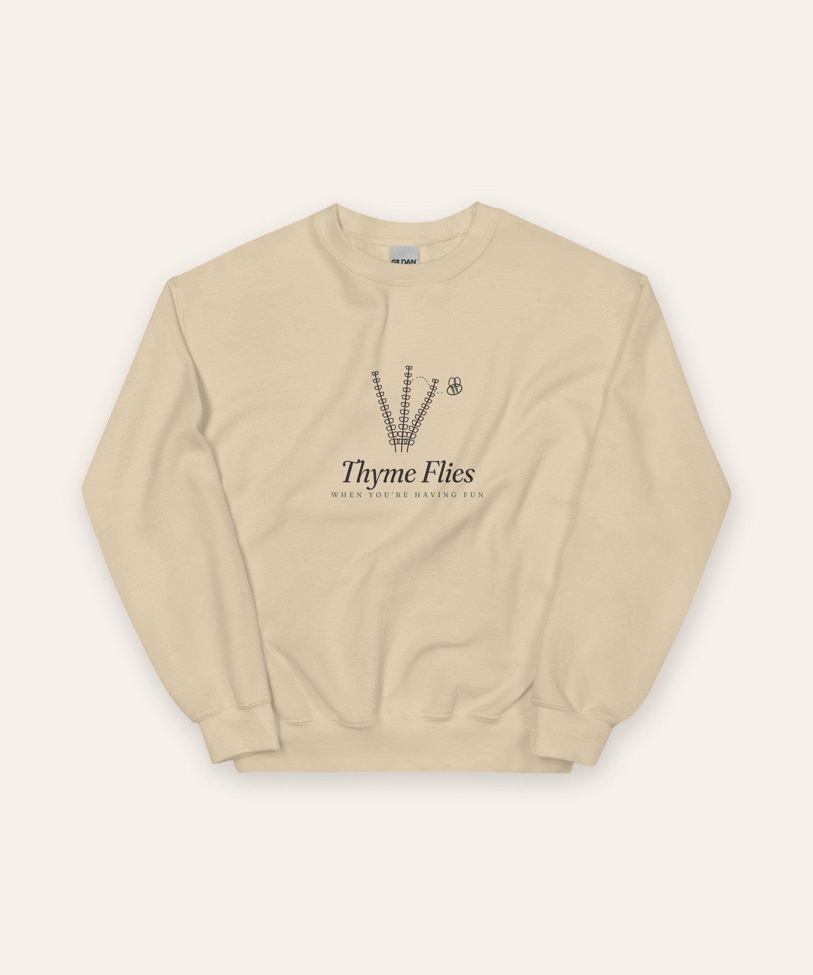 The Thyme Flies Crewneck in Sand, flat lay front, product shot on cream