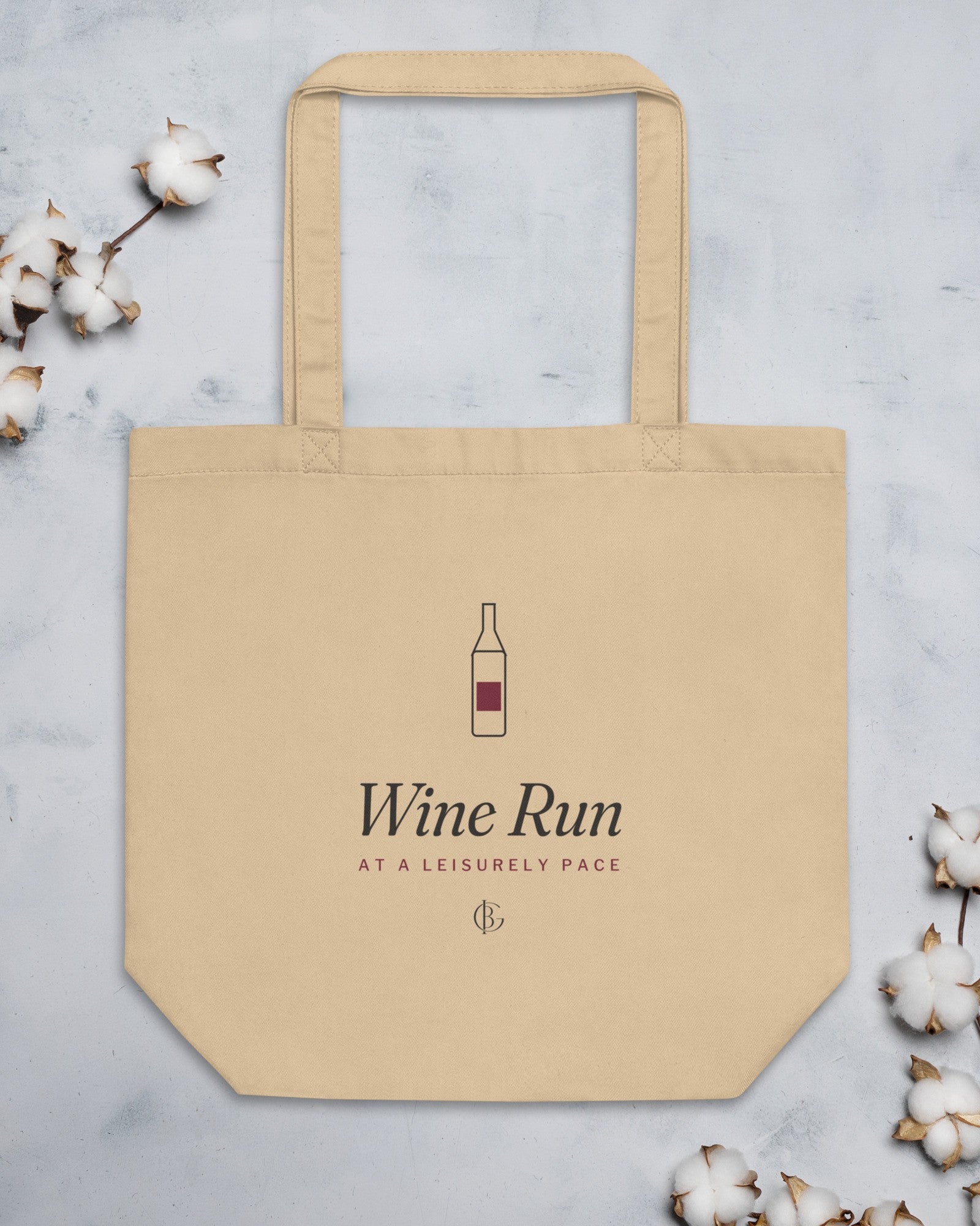 The Wine Run Tote flat on stone with cotton stems