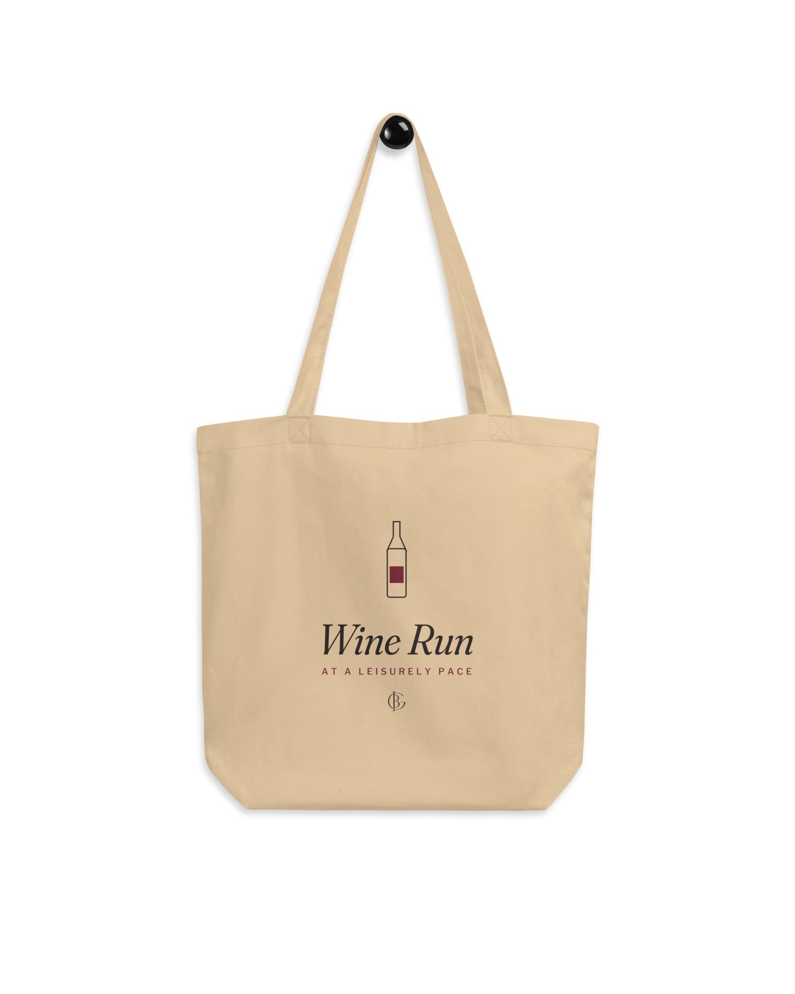 The Wine Run Tote hanging on a hook