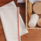 The Small Talk Kitchen Towel folded in a kitchen basket