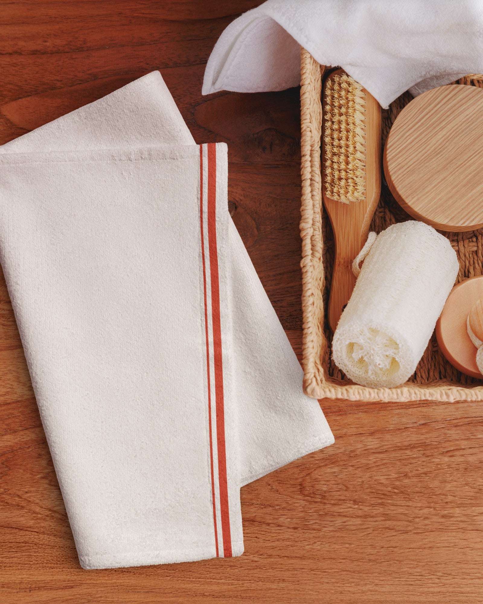 The Small Talk Kitchen Towel folded in a kitchen basket