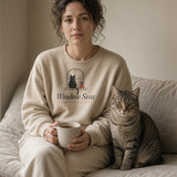 The Window Seat Crewneck in Sand, a woman in Sand on a window seat with tea, a cat in the same pose next to her