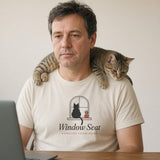 The Window Seat Tee in Ivory, a man (40s) on a video call, a cat walking across his shoulders