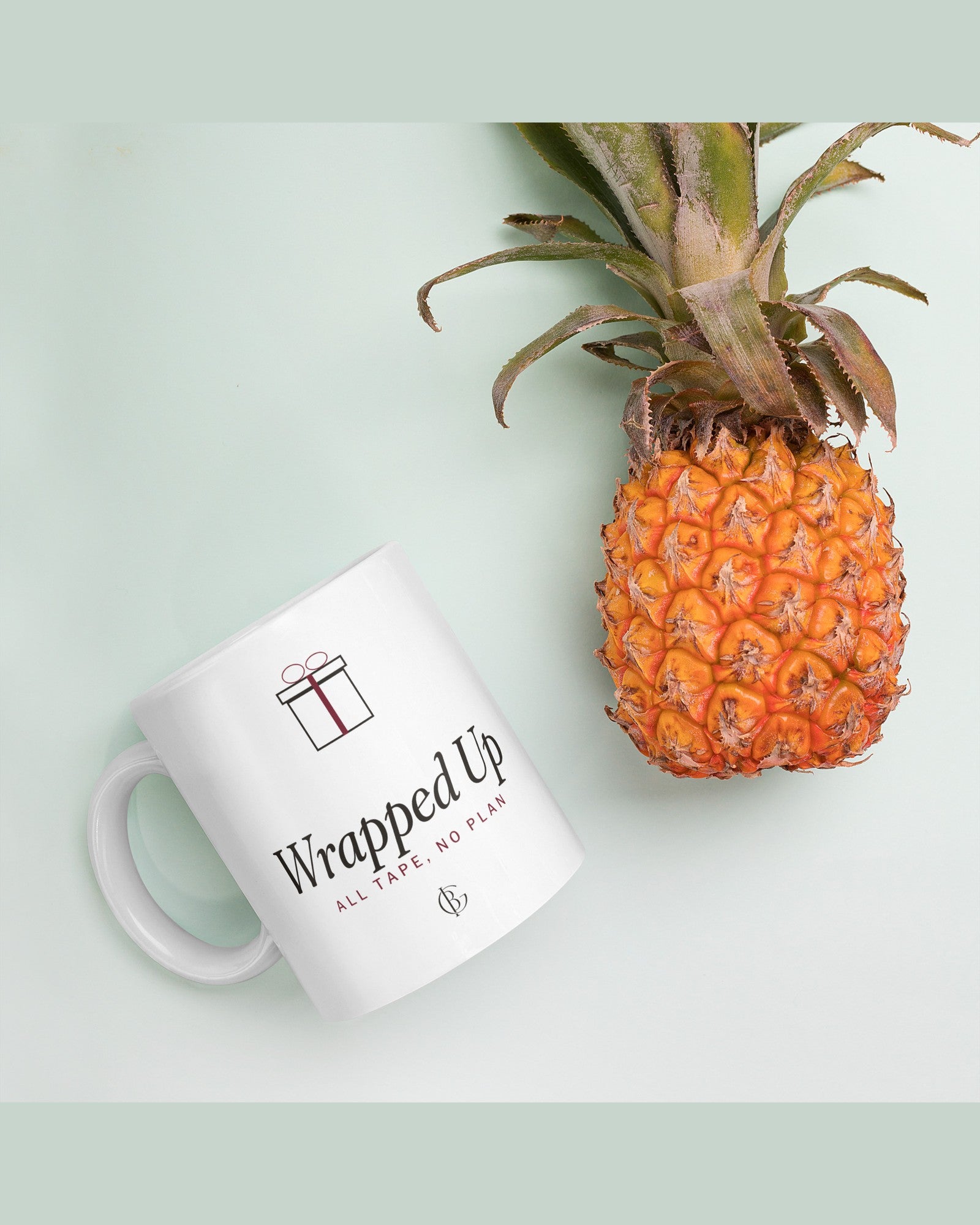 The Wrapped Up Mug in White, styled on a table